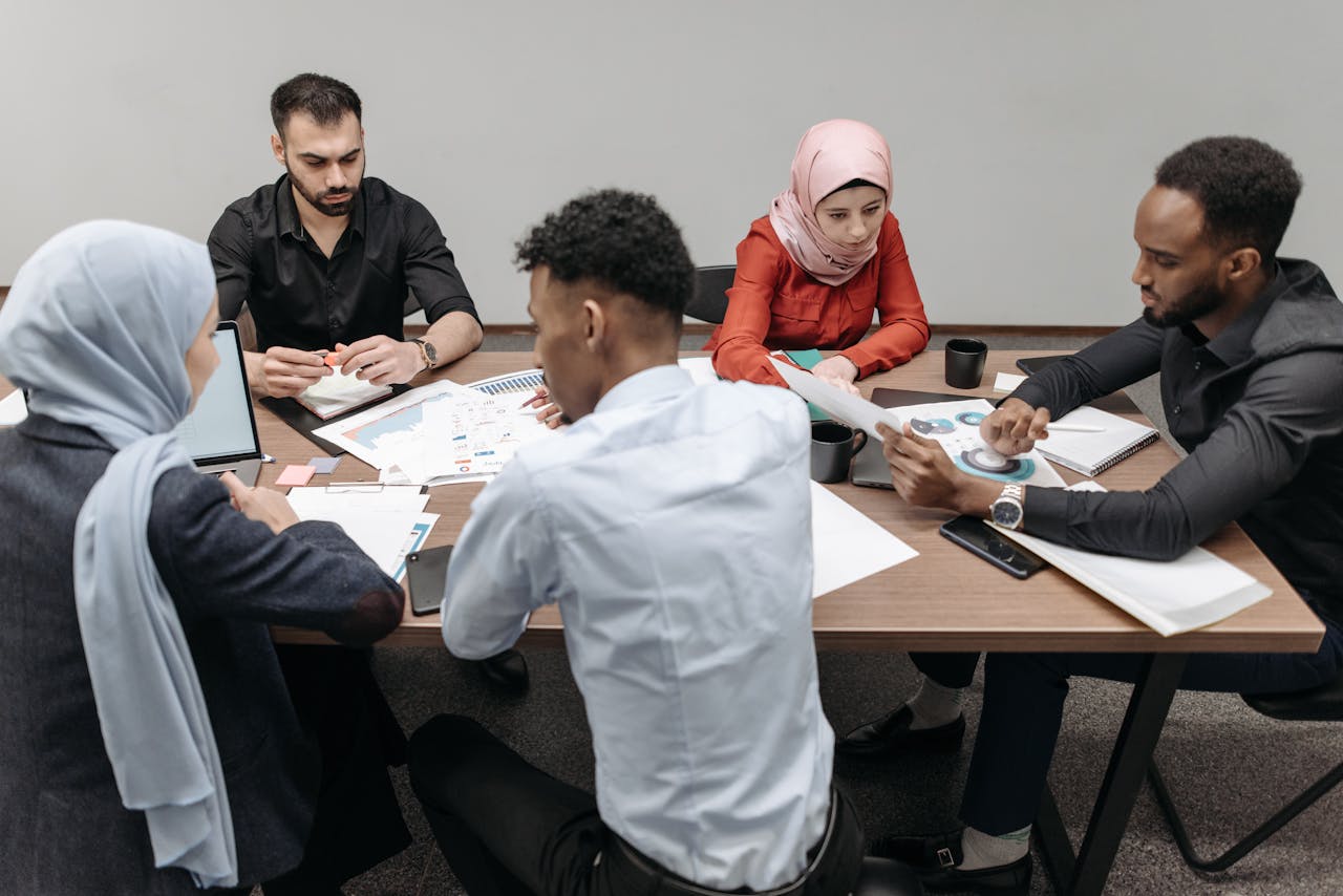 A diverse group of professionals having a collaborative meeting in a modern office setting.